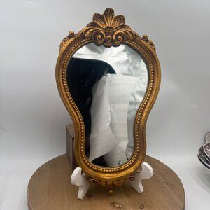 French-style ornate wall mirror, rococo or baroque decorative elements in a gil